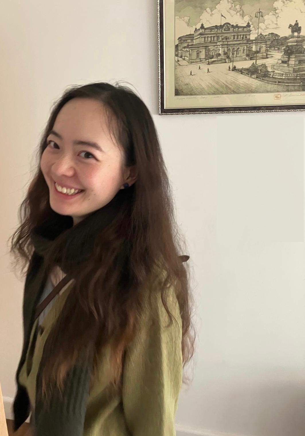 Binjie Zou smiling in a green cardigan